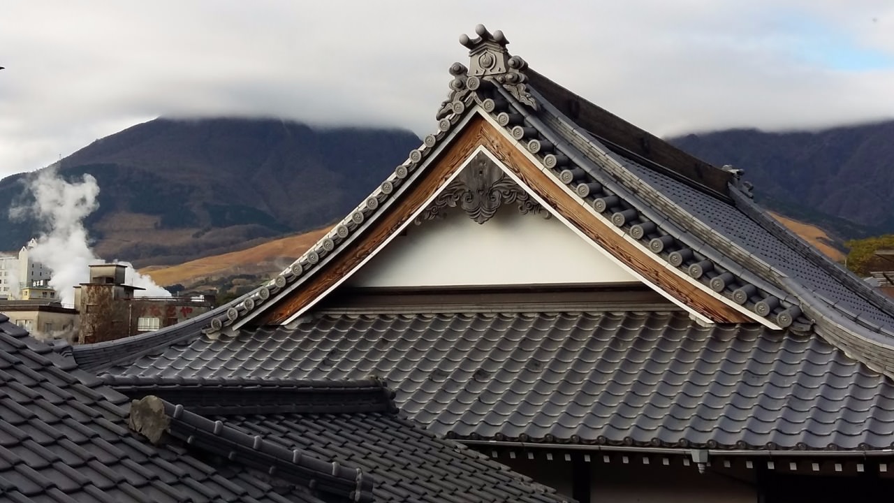 Beautiful roof and the mountains. Smokes of Beppu. Onsen area of Beppu. December 2015